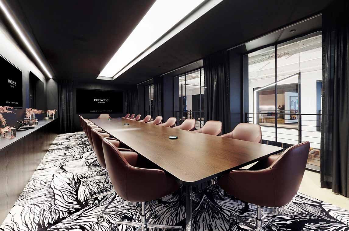 Warm brown conference table and chairs in an otherwise black and white conference room at Convene’s corporate office, furnished by Benhar.