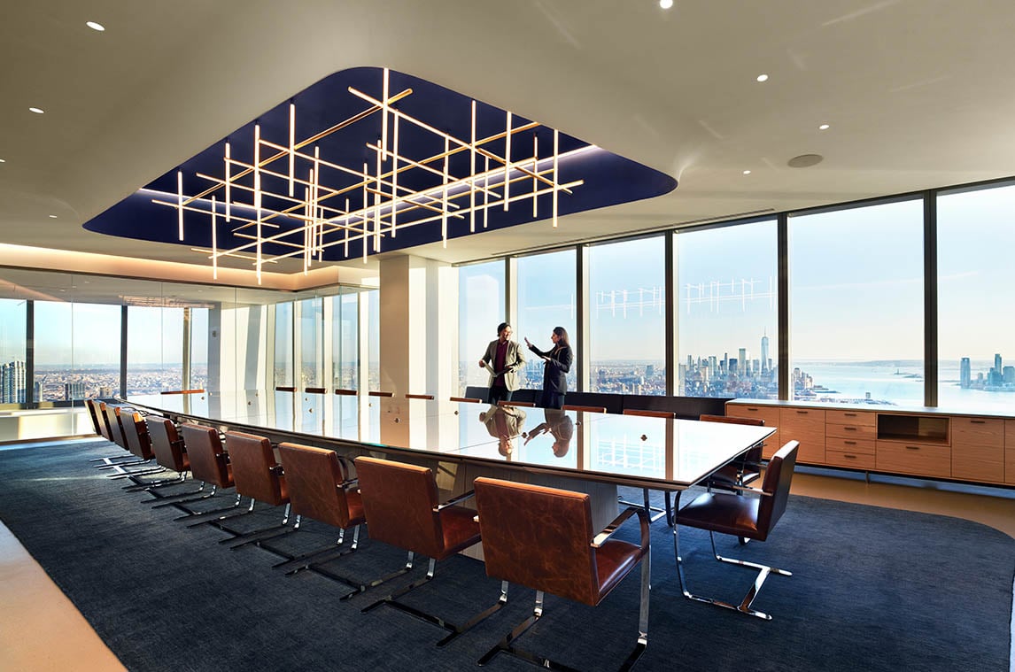 A unique light fixture comprised of various straight lines hangs above a conference table in WP Carey’s NYC office, furnished by Benhar.