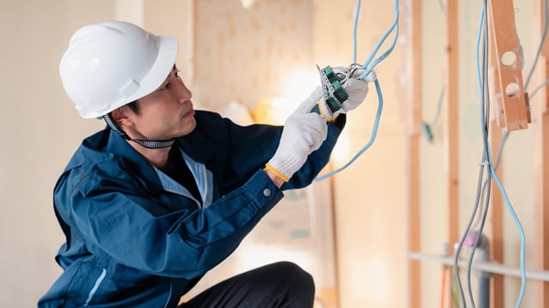 electrician installing wiring at an office