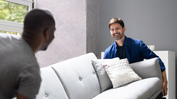 Two men moving furniture